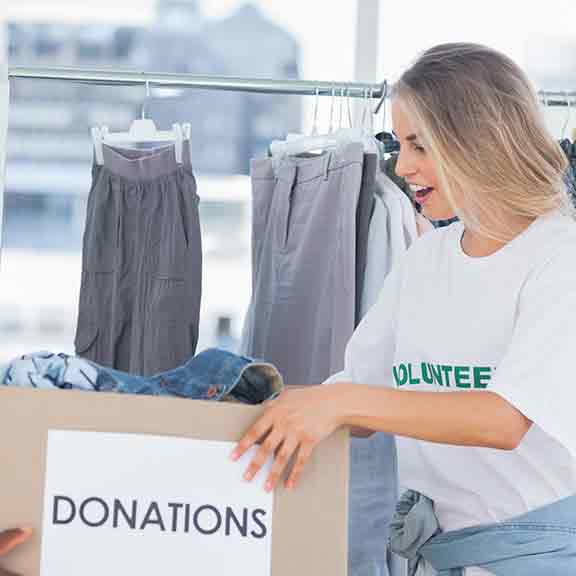 two people hold donations box