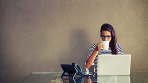 woman on computer having coffee