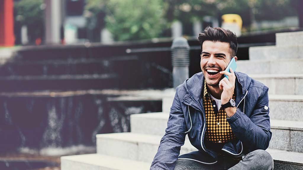 young man on steps using mobile