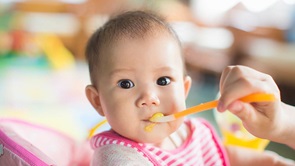 feeding baby with spoon