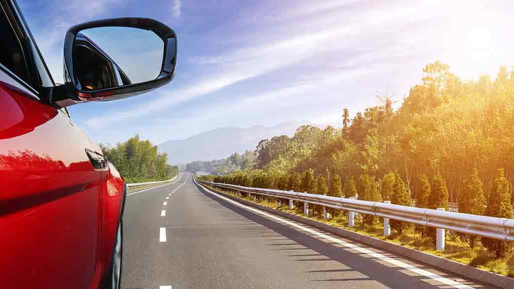 car mirror and open road